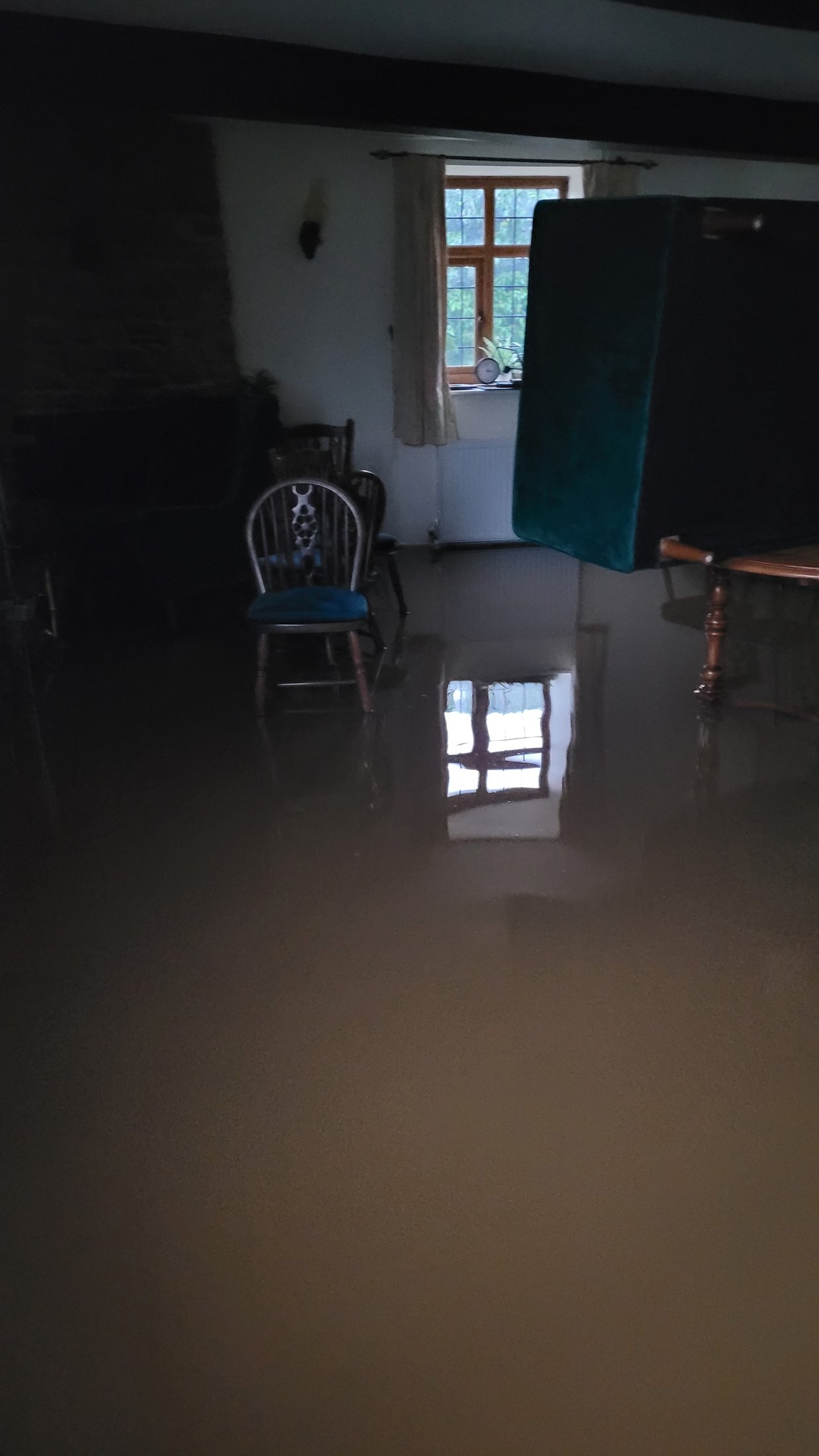 Deep floodwater across a ground-floor living space